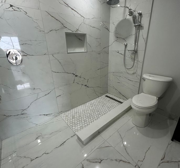 Bathroom with
          white tiles installed